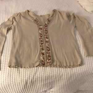 Pictures tee with long bell sleeves. Embroidered flowers down center front.